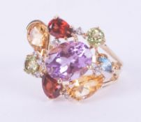 A 9ct yellow gold ring set with a mixture of oval cut, pear shaped and round cut amethyst,
