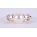 An 18ct yellow gold ring (not hallmarked or tested) set with a central cultured pearl,