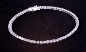 A fine 18ct white gold line bracelet set with approx. 2.92 carats of round brilliant cut diamonds,