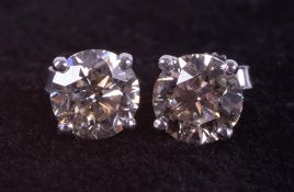 A pair of 18ct white gold four claw studs set with approximately 2.00 carats of round brilliant