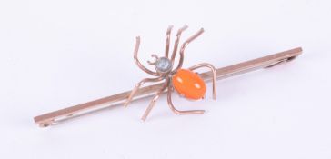 A 9ct rose gold spider brooch set with a small round blue topaz & a cabochon cut orange stone?,