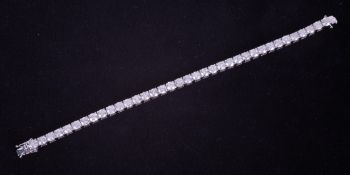 An impressive 18ct white gold line bracelet set with approximately 14.10 carats of round brilliant