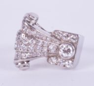 An impressive platinum 1950's ring in the style of the Art Deco period in a geometric scroll