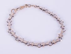 An antique yellow & white gold albert bracelet (tested to 9ct as per information receipt), with
