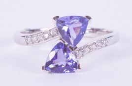 A 9ct white gold ring set with two triangular cut tanzanite's, AA quality, 1.50 carats with 0.13