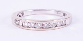 An 18ct white gold half eternity style ring set with approximately 0.35 carats of round brilliant