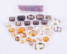 A mixed selection of loose gemstones to include a 16.50 carat oval cut yellow beryl, 9 x rectangular