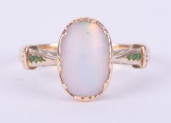 An antique yellow gold (no hallmarks & not tested) ring set with an oval cabochon cut white opal,