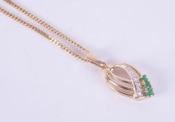 A 14k yellow gold pendant set with approx. 0.06 carats of round cut diamonds in an illusion