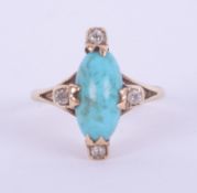A 14k yellow gold ring set with an elongated oval cabochon cut turquoise, measuring approx. 13mm x