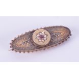 A 15ct yellow gold ornate Victorian brooch set with a round cut ruby & seed pearls, length 4.5cm,