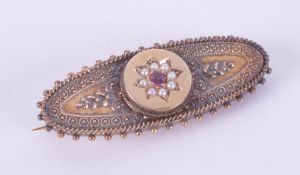 A 15ct yellow gold ornate Victorian brooch set with a round cut ruby & seed pearls, length 4.5cm,