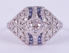 An ornate platinum Art Deco style ring set with a central round cut diamond, 0.51 carats and