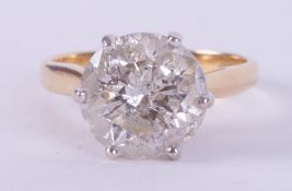 An 18ct yellow gold & platinum six claw solitaire ring set with approx. 3.20 carats of round