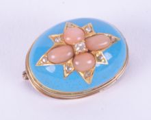 An antique yellow gold oval brooch set with coral & small old cut diamonds and turquoise coloured