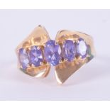 An unusual designed 14k yellow gold ring set with five oval cut tanzanite's, 4.17gm, size K 1/2.
