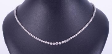 An 18ct white gold necklace set with graduated sizes of round brilliant cut diamonds, approximate