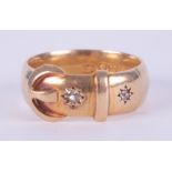 An 18ct yellow gold buckle design ring set with two small round cut diamonds, 3.96gm, size Q to Q