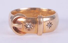 An 18ct yellow gold buckle design ring set with two small round cut diamonds, 3.96gm, size Q to Q