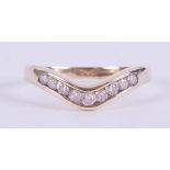 A 9ct yellow gold wishbone ring set with approximately 0.25 carats of round brilliant cut