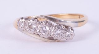 An 18ct yellow gold & platinum crossover style ring set with five small round cut diamonds in an