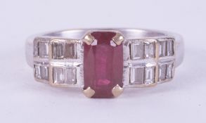 An 18ct white gold ring set with an emerald cut ruby, approx. 1.00 carat, with baguette cut diamonds