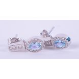 A pair of 14k white gold reversable earrings set with oval cut blue topaz, approx. total weight 0.46