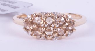 A 9ct yellow gold ring set with eight round cut champagne diamonds, total weight 0.56 carats