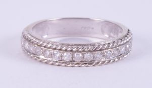 A 9ct white gold half eternity ring with rope twist design edges and set with approx. 0.34