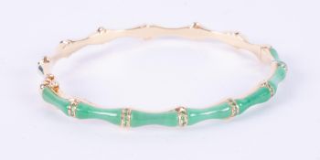 An 18ct yellow gold bamboo design bangle set half way around with jade and interspaced with small