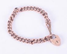 A 9ct rose gold curb link heart padlock bracelet with safety chain, 14.05gm.