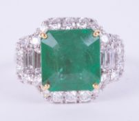 An impressive 18ct white & yellow gold ring set centrally with a square cut emerald, approx. 4.95