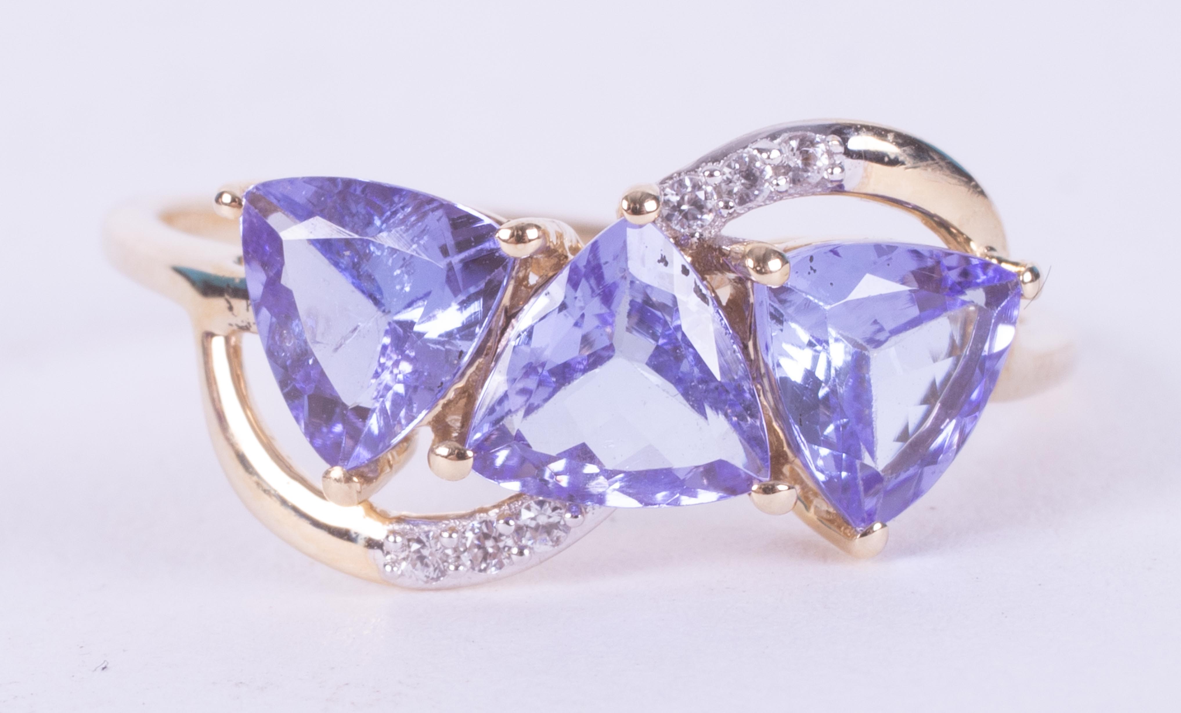 A 9ct yellow gold ring set with three triangular cut tanzanite's, AA quality, 2.10 carats total