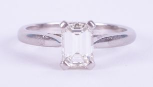 A platinum four claw ring set with 0.77 carats of emerald cut diamond, approx. colour H-I and VS2