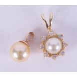 Two pearl set pendants, one 14k yellow gold in the design of a flower with the pearl set centrally
