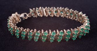 A 925 silver & gold plated three row bracelet set with round cut emeralds, total weight of