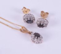 A set comprising of a 9ct yellow & white gold cluster pendant set with a central oval cut dark