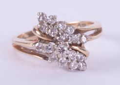 An 18ct yellow gold crossover style ring set with small round brilliant cut diamonds, 3.55gm, size