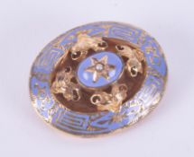 An antique yellow gold brooch (no hallmarks & not tested) in an ornate oval setting with blue enamel