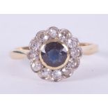 An 18ct yellow gold & platinum flower cluster ring set with a central round cut sapphire approx. 0.