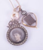 A gold & black enamel George II heart shaped mourning locket with an old oval cut diamond to the top