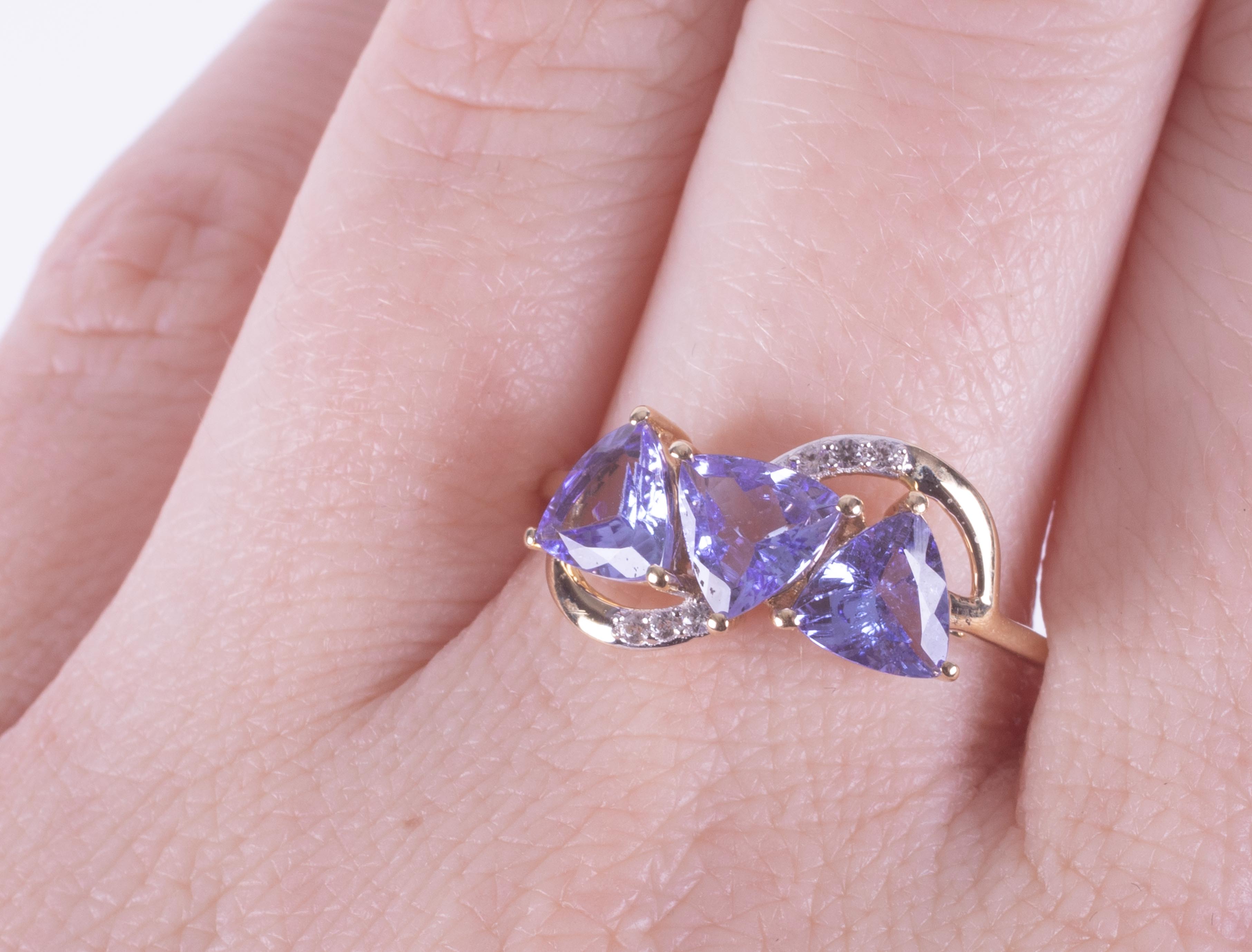 A 9ct yellow gold ring set with three triangular cut tanzanite's, AA quality, 2.10 carats total - Image 2 of 2