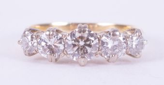 An 18ct yellow & white gold ring set with five older cut round diamonds, total weight of diamonds is