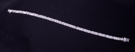 A 14k white gold line bracelet set with a mixture of round & baguette cut diamonds, length 16.5cm (