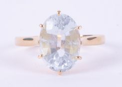 An 18ct yellow gold ring set with an oval cut aquamarine, measuring approx. 13.5mm x 9.8mm, 5.