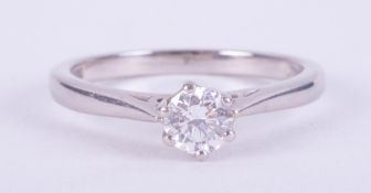 A platinum six claw solitaire set with a round brilliant cut diamond, approx. 0.60 carats, colour