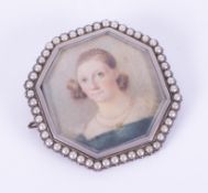 An antique silver (hallmarks are indistinct on reverse) portrait brooch of a lady in a blue dress,