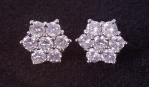 A pair of 18ct white & yellow gold flower cluster earrings set with round brilliant cut diamonds,
