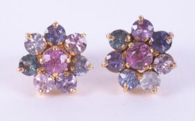A pair of high carat (not hallmarked or tested) flower cluster earrings set with a mixture of