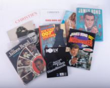 A James Bond poster (rolled), together with various auction catalogues, James Bond annuals,